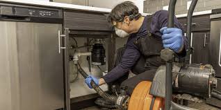 Plumber repairing under sink pipes in San Mateo CA